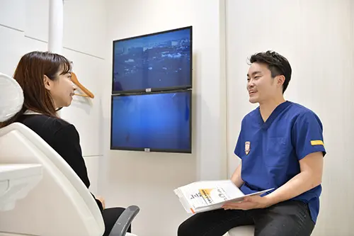 笑顔で会話する歯科医師と患者